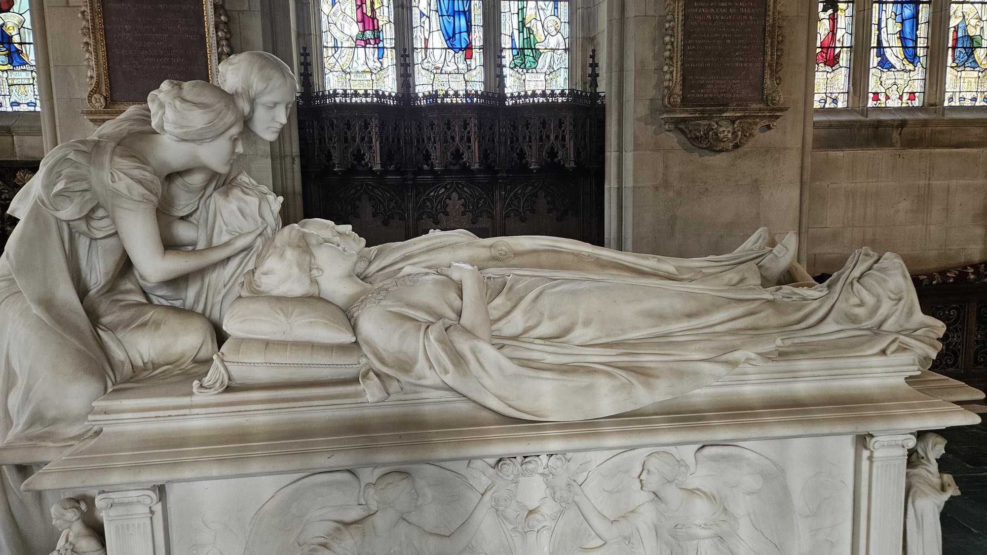 The memorial tomb to Mary, wife of Lord George Curzon, who died in 1906 at the age of 36. The chapel was added in 1908 and designed by G. F. Bodley. The tomb itself is a striking thing: a table tomb in white marble with effigies of Lord Curzon (the former Viceroy of India) and his wife, with two angels holding the crown of life leaning over them.

An interesting fact: Lord Curzon is depicted with one of his feet uncovered, meaning he was alive when he posed for the effigy.